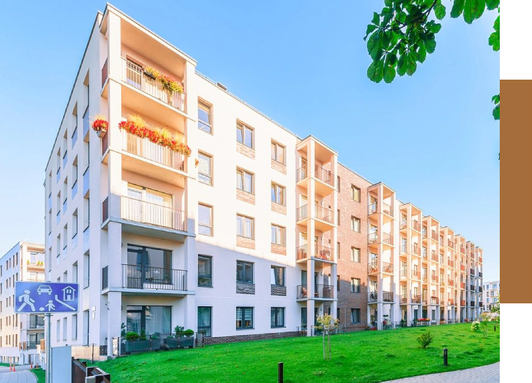 A large white building with many balconies on it.